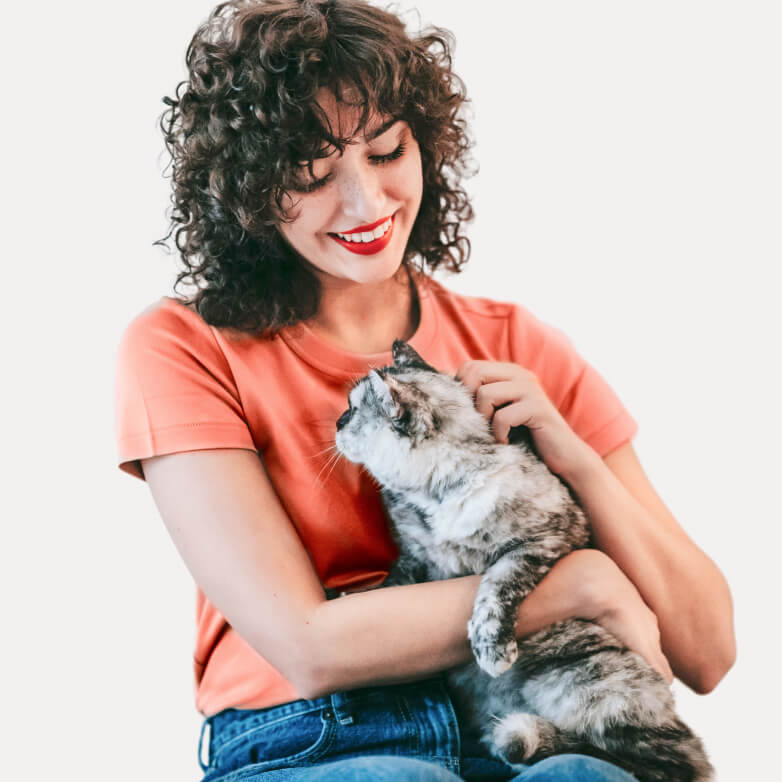 woman smiling with a cat in her arm
